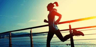 Woman running at sunset